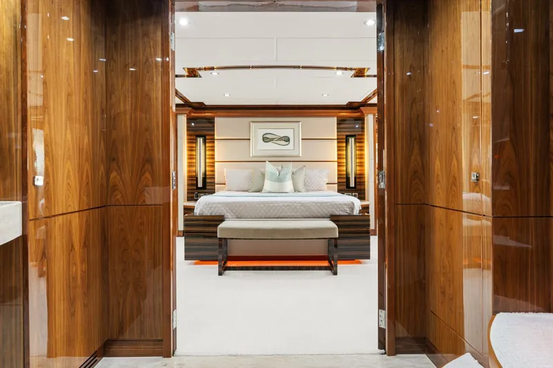 Mesmerize Yacht Photos Pics Luxurious bedroom interior on 2013 Hargrave 125 Raised Pilothouse yacht, featuring elegant wood finishes.