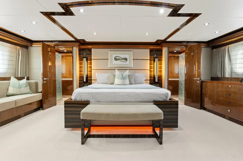 Mesmerize Yacht Photos Pics Luxurious bedroom interior of 2013 Hargrave 125 Raised Pilothouse yacht, featuring elegant wood finishes.