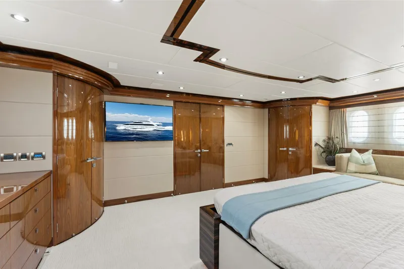 Mesmerize Yacht Photos Pics Luxurious bedroom interior of 2013 Hargrave 125 Raised Pilothouse yacht with elegant wood finishes.