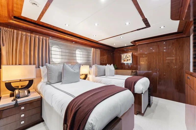 Mesmerize Yacht Photos Pics Luxurious twin bedroom on 2013 Hargrave 125 Raised Pilothouse yacht, featuring elegant wood finishes.
