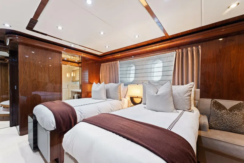 Mesmerize Yacht Photos Pics Luxurious twin bedroom on 2013 Hargrave 125 Raised Pilothouse yacht, featuring elegant wood finishes.
