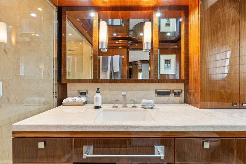 Mesmerize Yacht Photos Pics Luxurious bathroom vanity on 2013 Hargrave 125 Raised Pilothouse yacht, featuring elegant wood and marble finishes.