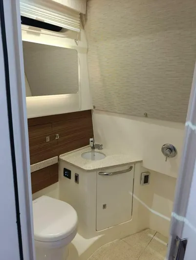  Yacht Photos Pics 2024 Boston Whaler 420 Outrage bathroom with modern fixtures and sleek design.
