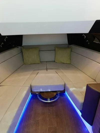  Yacht Photos Pics 2024 Boston Whaler 420 Outrage cabin interior with beige seating and blue LED lighting.