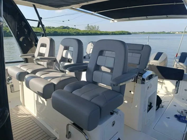  Yacht Photos Pics 2024 Boston Whaler 420 Outrage boat interior with luxurious seating and helm station.