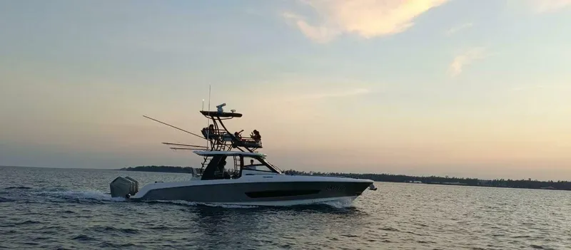  Yacht Photos Pics 2024 Boston Whaler 420 Outrage cruising at sunset on open water.
