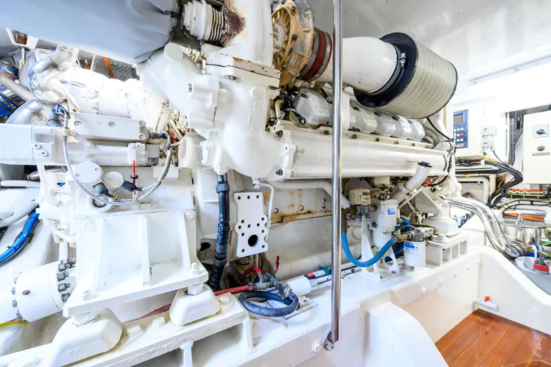 Weapon Yacht Photos Pics Engine room of 1999 Norman Wright 63 Sport Fisher, showcasing complex machinery and components.