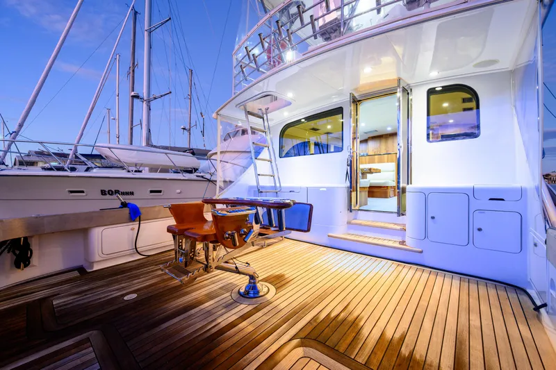 Weapon Yacht Photos Pics Luxurious 1999 Norman Wright 63 Sport Fisher yacht with elegant wooden deck at sunset.