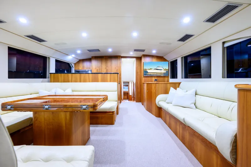 Weapon Yacht Photos Pics Luxurious interior of a 1999 Norman Wright 63 Sport Fisher yacht with elegant seating and wood finishes.