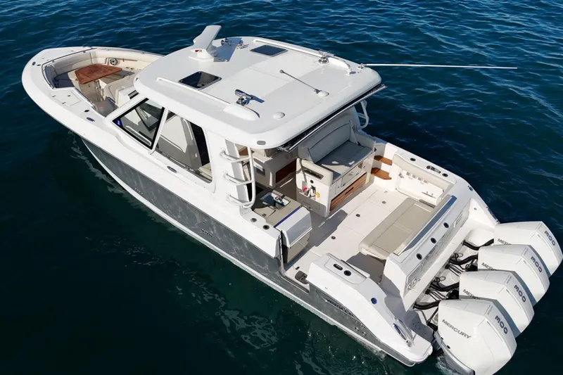 True Story Yacht Photos Pics 2022 Boston Whaler 380 Realm boat on water, featuring spacious deck and triple Mercury engines.