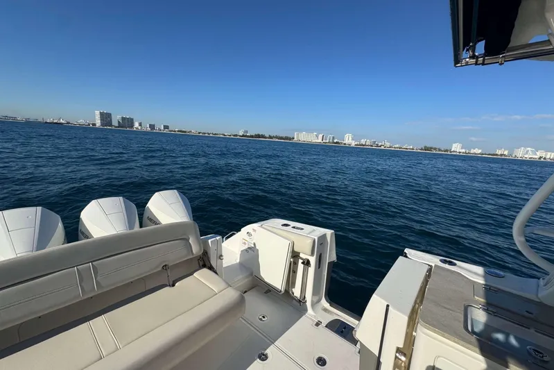 True Story Yacht Photos Pics Boston Whaler 380 Realm 2022 on open water with city skyline in background.