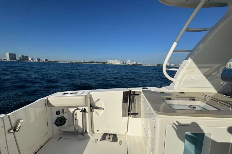 True Story Yacht Photos Pics Boston Whaler 380 Realm 2022 on open water with city skyline in background.