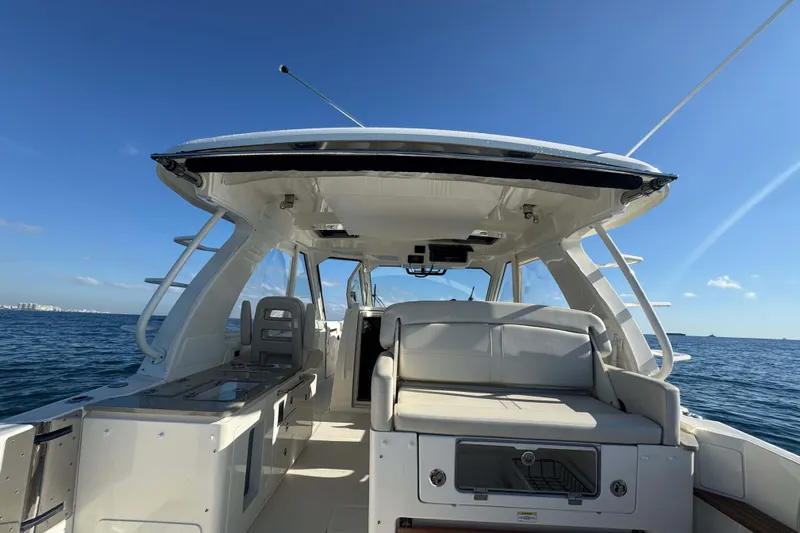 True Story Yacht Photos Pics 2022 Boston Whaler 380 Realm boat interior with seating, ocean view, and clear sky.
