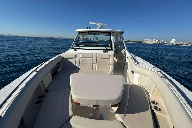 True Story Yacht Photos Pics 2022 Boston Whaler 380 Realm boat on open water, featuring spacious seating and clear skies.