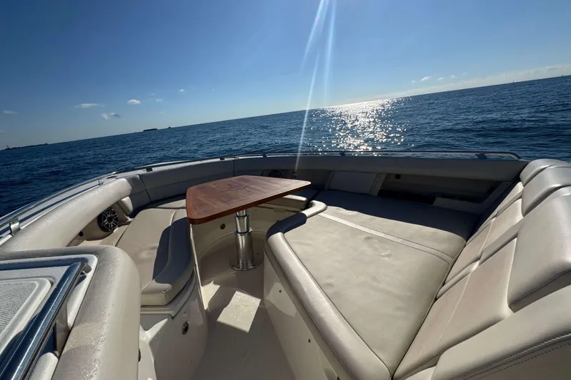 True Story Yacht Photos Pics 2022 Boston Whaler 380 Realm boat interior with ocean view and seating area.