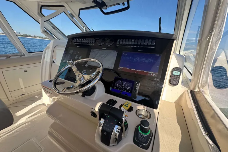 True Story Yacht Photos Pics 2022 Boston Whaler 380 Realm helm with advanced navigation displays and controls.