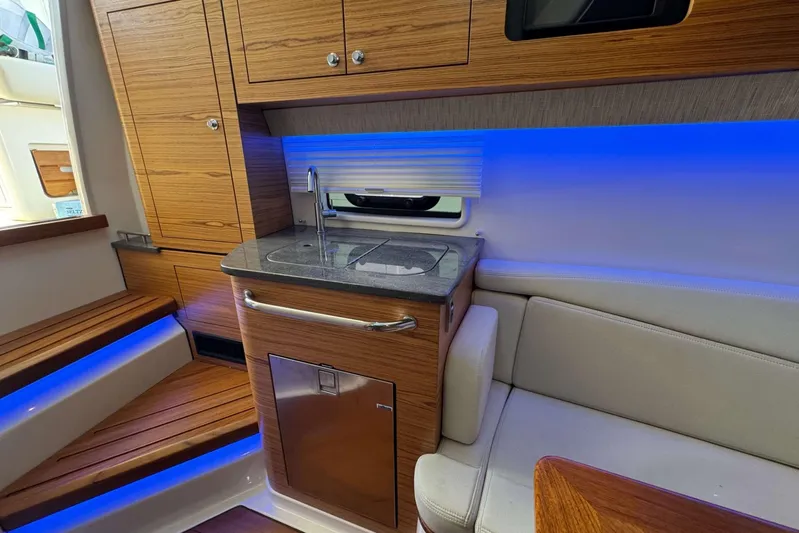True Story Yacht Photos Pics Interior of 2022 Boston Whaler 380 Realm with modern kitchenette and ambient lighting.