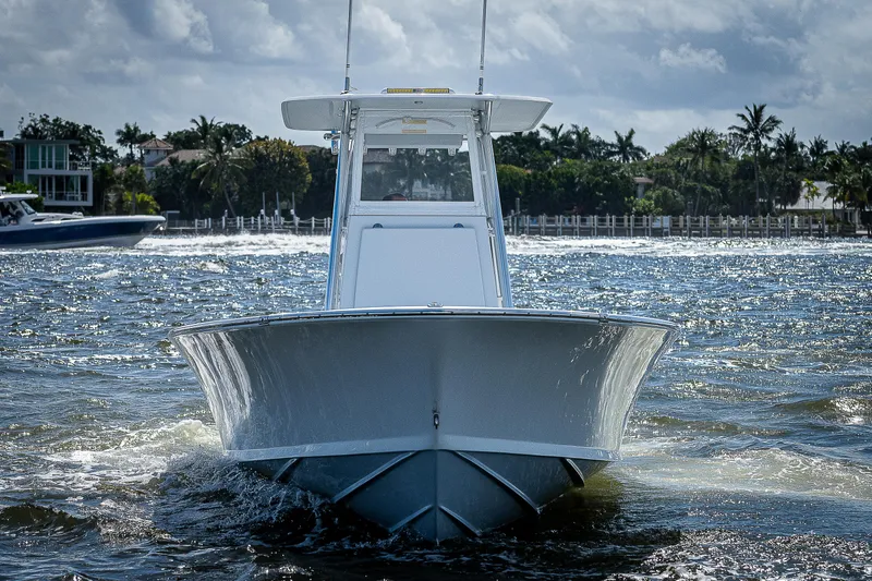  Yacht Photos Pics 1969 Bertram 25 Moppie boat cruising on water, front view.
