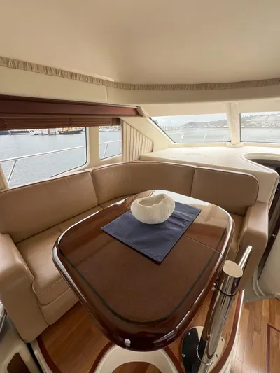 Viva La Vida Yacht Photos Pics 2006 Sea Ray 44 Sedan Bridge interior with elegant seating and polished wooden table.