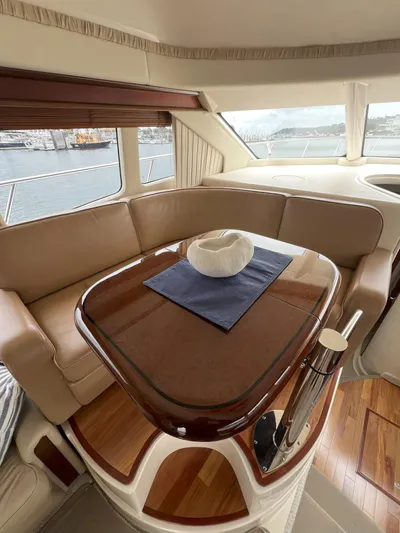 Viva La Vida Yacht Photos Pics Interior of 2006 Sea Ray 44 Sedan Bridge with elegant seating and polished wood table.