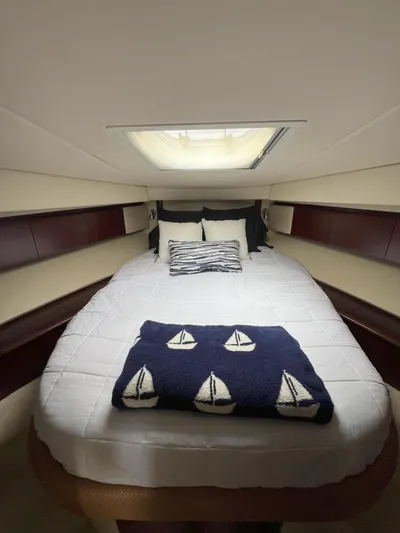 Viva La Vida Yacht Photos Pics 2006 Sea Ray 44 Sedan Bridge cabin with cozy bed and nautical-themed decor.