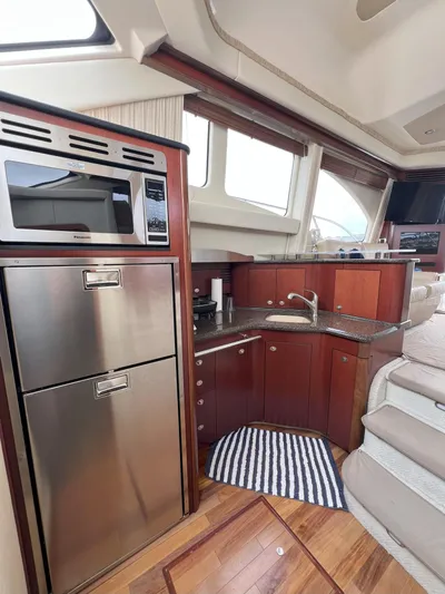 Viva La Vida Yacht Photos Pics Luxurious 2006 Sea Ray 44 Sedan Bridge yacht interior with modern kitchen amenities.