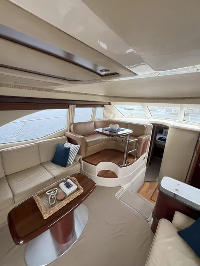 Viva La Vida Yacht Photos Pics Luxurious interior of 2006 Sea Ray 44 Sedan Bridge yacht with elegant seating and table.