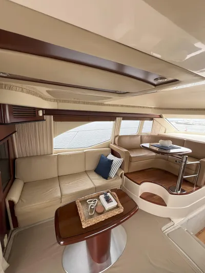 Viva La Vida Yacht Photos Pics Luxurious interior of 2006 Sea Ray 44 Sedan Bridge yacht with elegant seating and table.