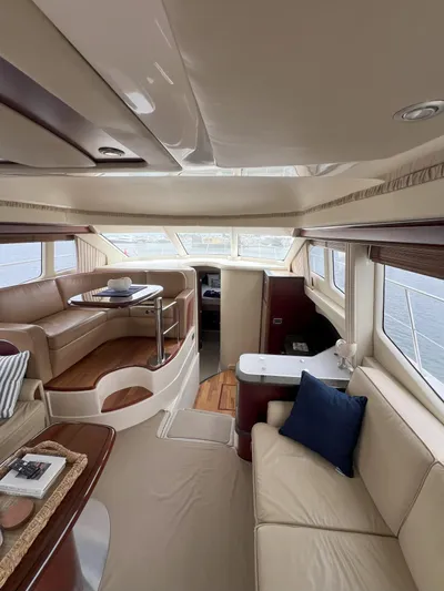 Viva La Vida Yacht Photos Pics Luxurious interior of a 2006 Sea Ray 44 Sedan Bridge yacht with elegant seating and dining area.