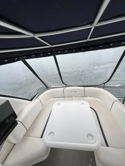 Viva La Vida Yacht Photos Pics 2006 Sea Ray 44 Sedan Bridge interior with seating and table, overlooking water.