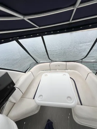 Viva La Vida Yacht Photos Pics 2006 Sea Ray 44 Sedan Bridge interior with seating and table, overlooking water.