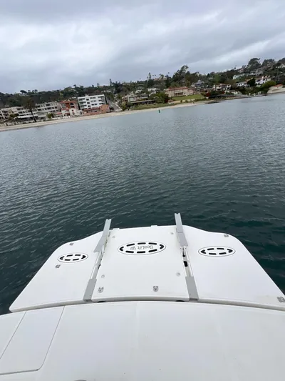 Viva La Vida Yacht Photos Pics 2006 Sea Ray 44 Sedan Bridge yacht on calm waters near a coastal town.