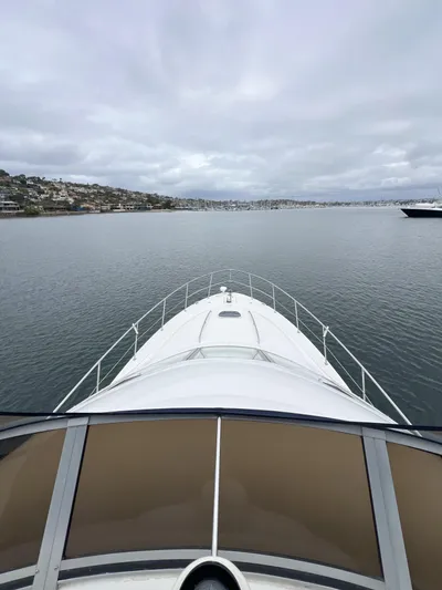 Viva La Vida Yacht Photos Pics 2006 Sea Ray 44 Sedan Bridge yacht cruising on calm waters under cloudy skies.