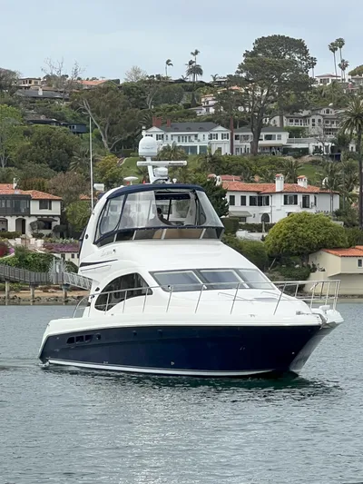 Viva La Vida Yacht Photos Pics 2006 Sea Ray 44 Sedan Bridge yacht on calm water with scenic coastal backdrop.