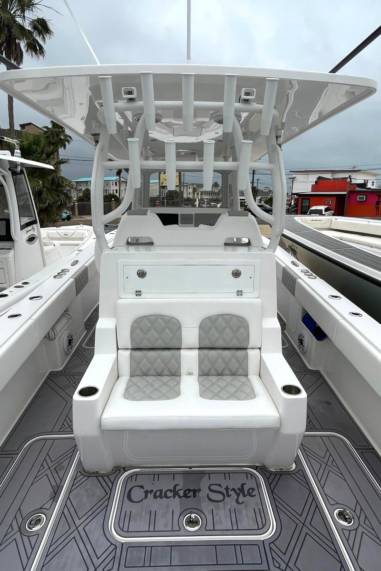 2024 Reef Runner 340 boat interior with cushioned seating and Cracker Style floor mat.