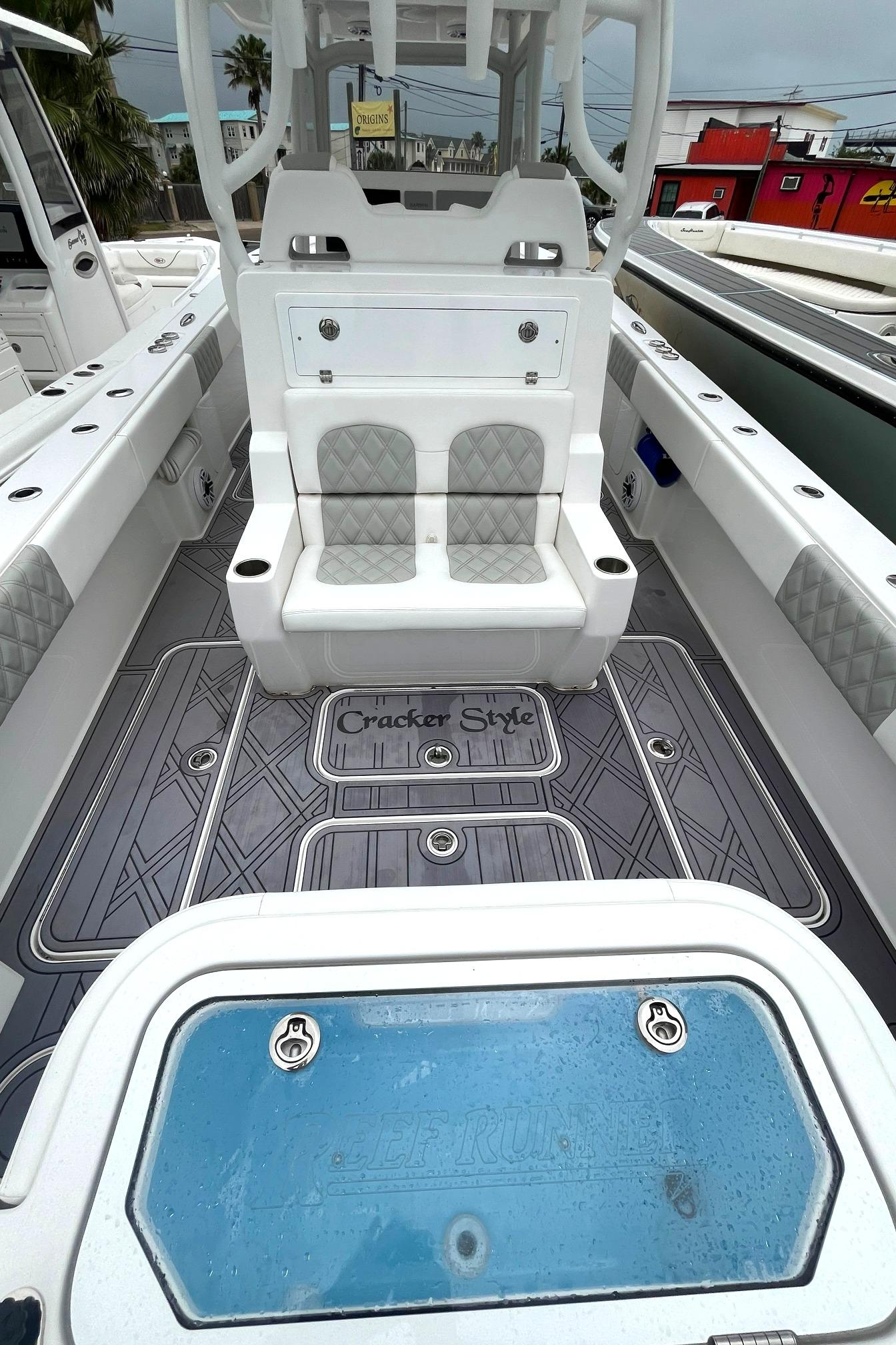 2024 Reef Runner 340 boat interior with seating and storage compartments.