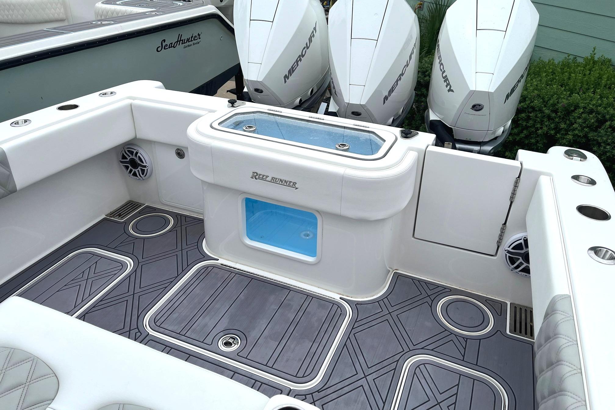 2024 Reef Runner 340 boat deck with triple Mercury outboard engines.