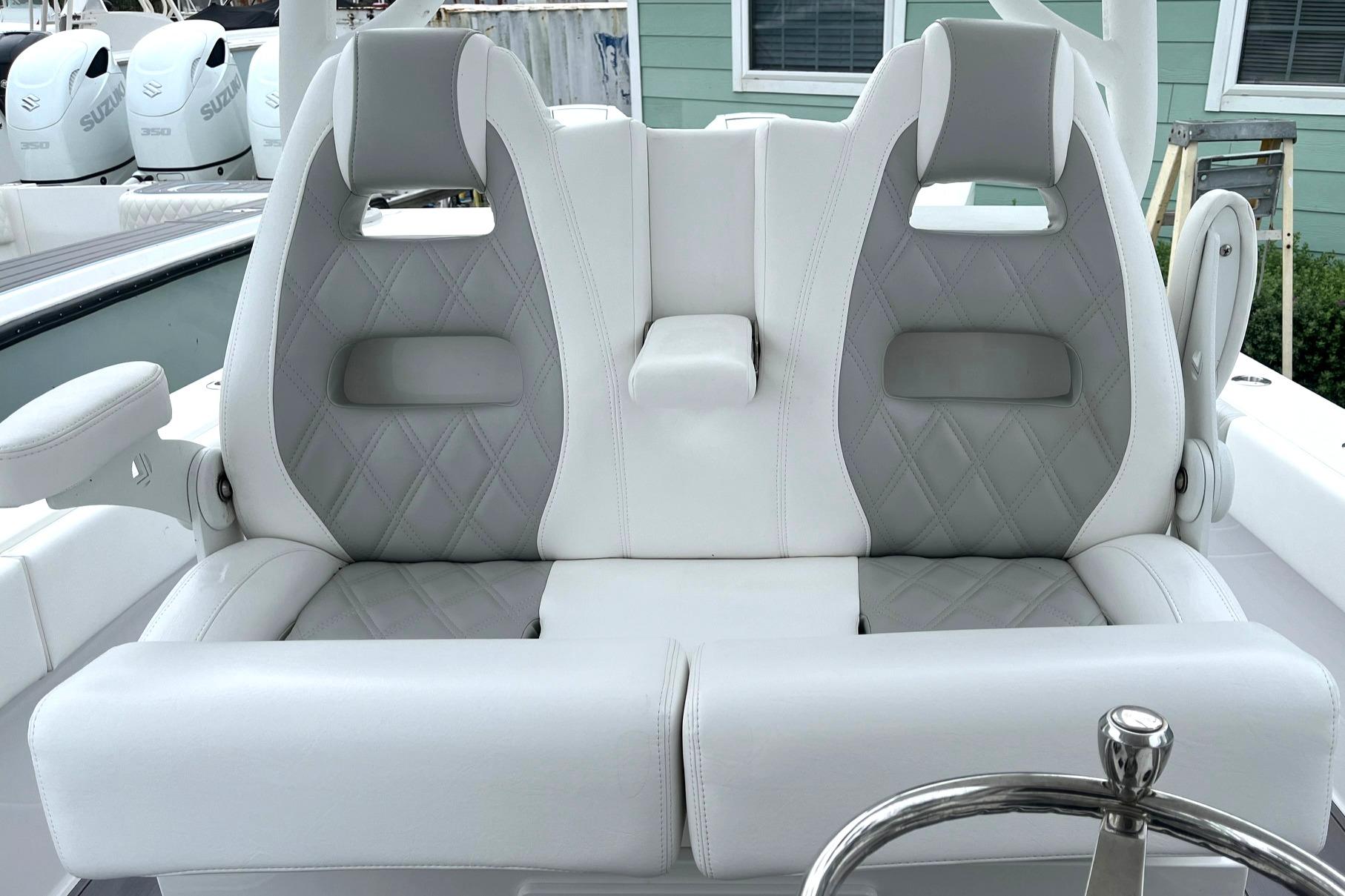 2024 Reef Runner 340 boat with dual cushioned seats and steering wheel.