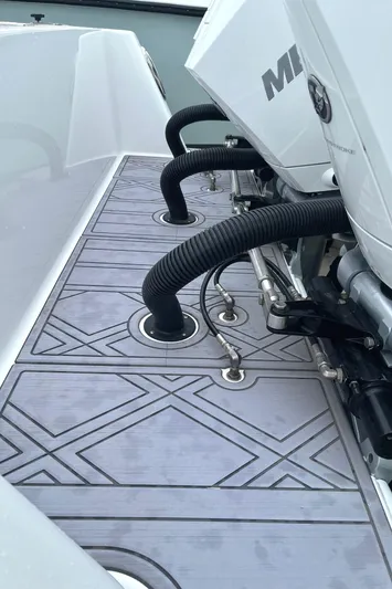  Yacht Photos Pics 2024 Reef Runner 340 boat deck with engine hoses and patterned flooring.