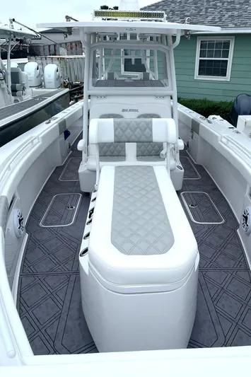  Yacht Photos Pics 2024 Reef Runner 340 boat with cushioned seating and modern design.