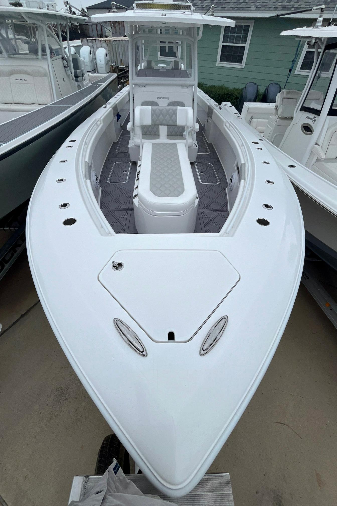 2024 Reef Runner 340 boat, white exterior, spacious deck, modern design, docked at marina.