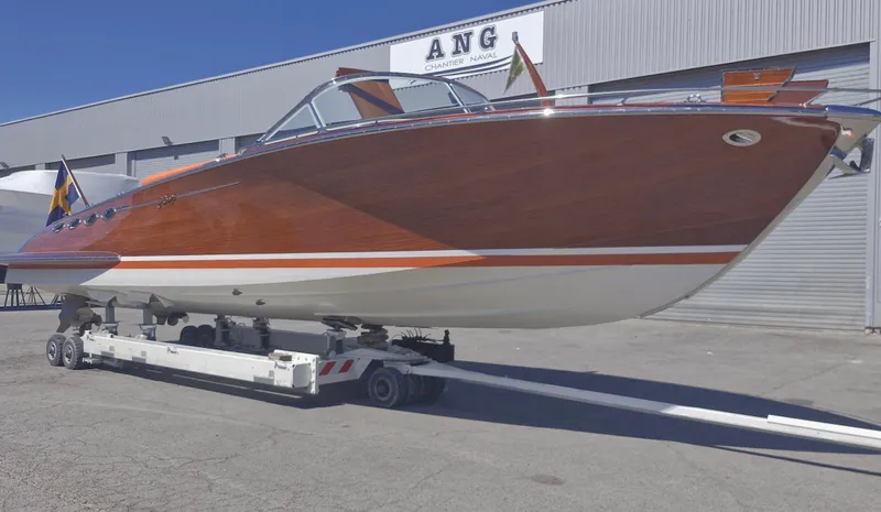  Yacht Photos Pics 2010 J Craft Torpedo 42 boat on trailer outside a warehouse.