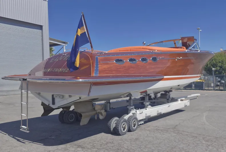  Yacht Photos Pics 2010 J Craft Torpedo 42 boat on trailer, wooden finish, docked outdoors.