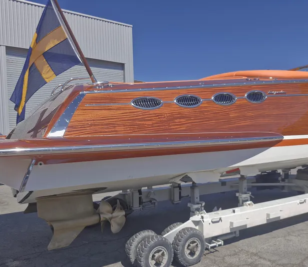  Yacht Photos Pics J Craft Torpedo 42 boat, 2010 model, with wooden finish and flag, on trailer.