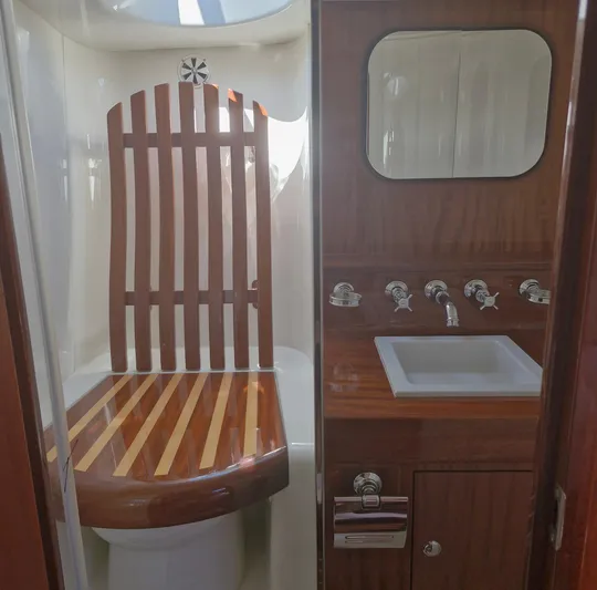  Yacht Photos Pics Luxurious bathroom interior of 2010 J Craft Torpedo 42 yacht with wooden accents.
