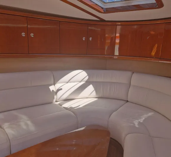  Yacht Photos Pics Luxurious interior of 2010 J Craft Torpedo 42 with elegant wood and leather seating.