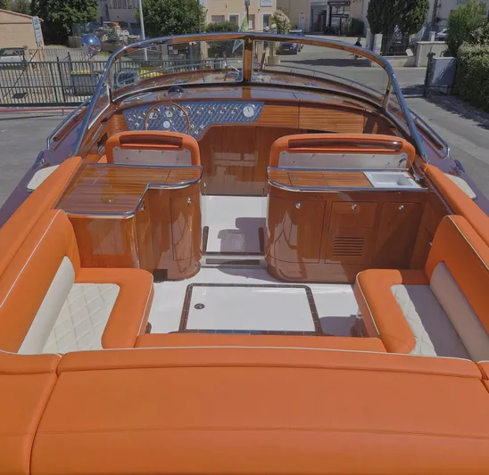  Yacht Photos Pics Luxurious 2010 J Craft Torpedo 42 boat interior with orange seating and polished wood finish.