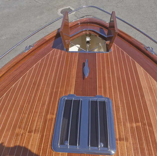 Yacht Photos Pics Bow of 2010 J Craft Torpedo 42 with polished wood finish and open hatch.