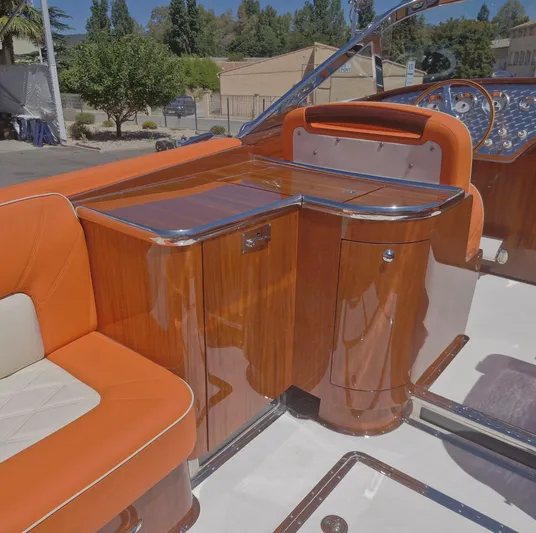  Yacht Photos Pics Luxurious interior of 2010 J Craft Torpedo 42 with polished wood and orange seating.