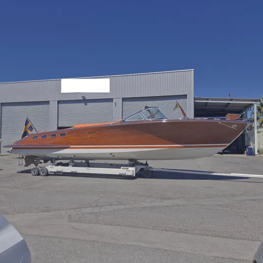  Yacht Photos Pics 2010 J Craft Torpedo 42 boat on trailer, parked outside industrial building.